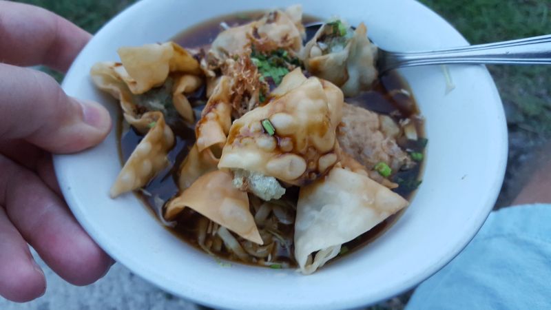 Streetfood Canggu. Soup with vegetables and other ingredients served in ceramic bowl and with metal spoon - plastic free so to say.